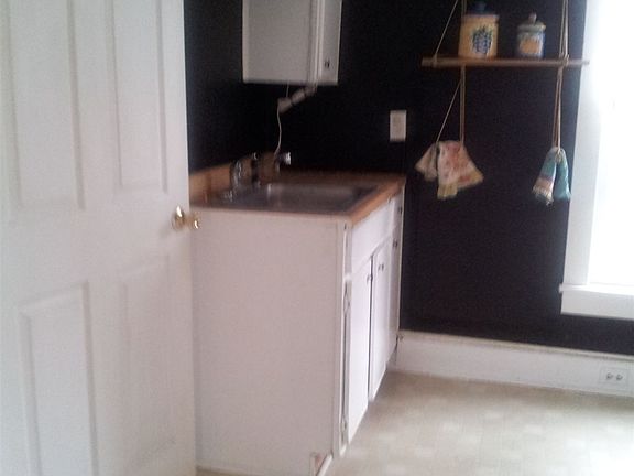 Kitchen sink area; door to half-bath or pantry
