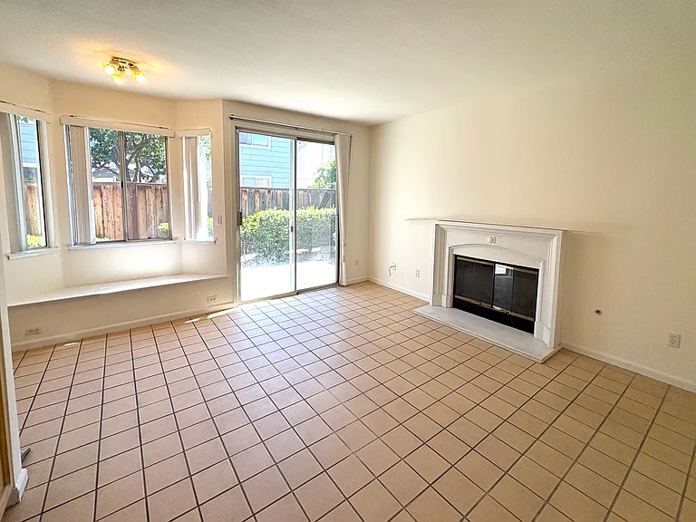 Spacious Family Room featuring a Cozy Fireplace & Direct Backyard Access