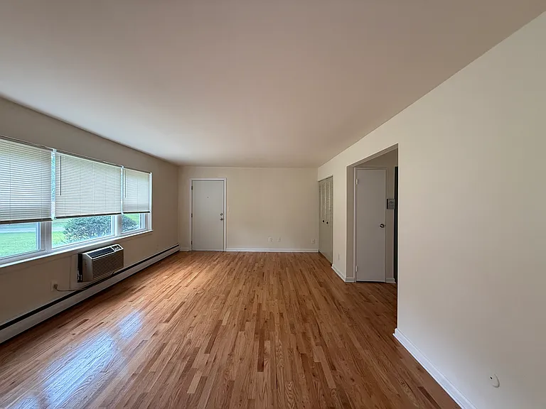 Large Living Room with HW Floors & new AC unit.