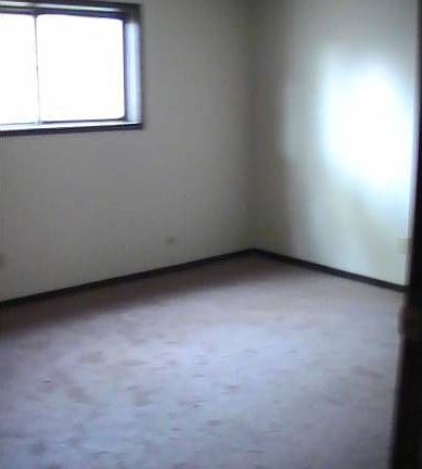 spacious bedroom with wal