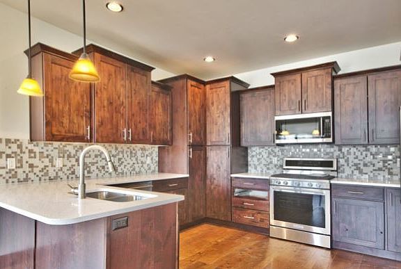 Kitchen has all stainless with granite and tile backsplash.