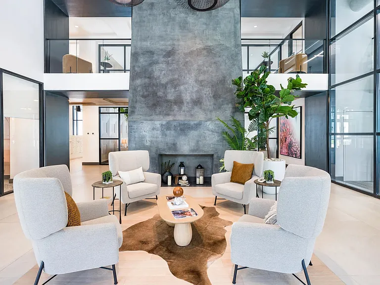 Stylish and inviting lounge space with high ceilings, modern seating, and a fireplace feature_perfect for casual conversation or quiet moments.