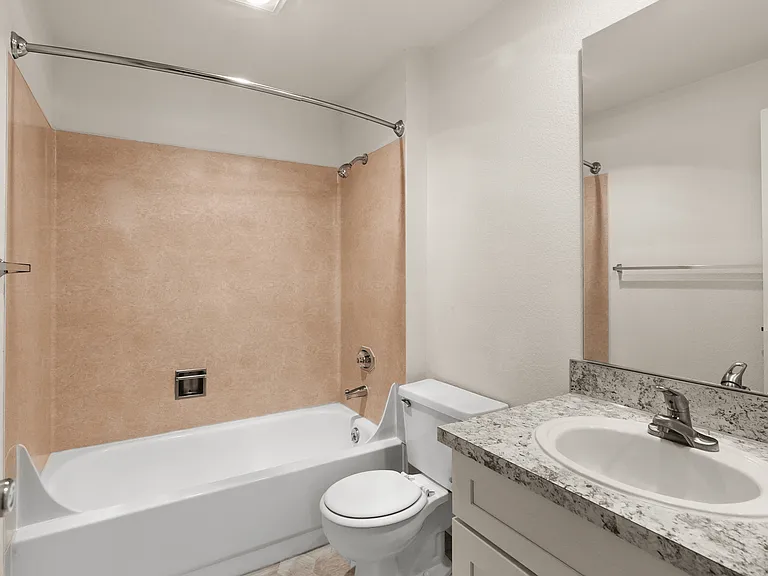 Modern bathroom featuring a luxurious bathtub, elegant marble countertop with sink, and sleek fixtures. Modern bathroom featuring a luxurious bathtub, elegant marble countertop with sink, and sleek fixtures.
