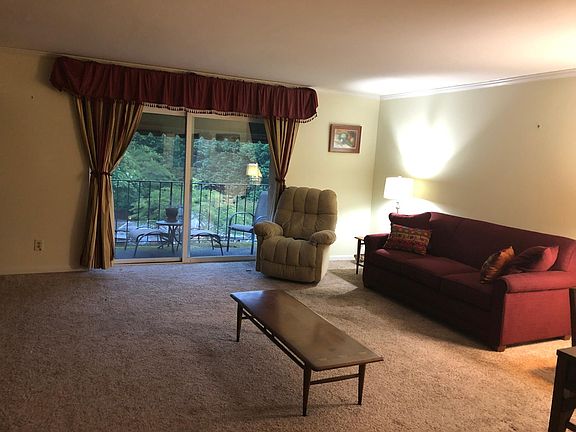The open Living Room/Dining Room looks out onto a furnished patio.