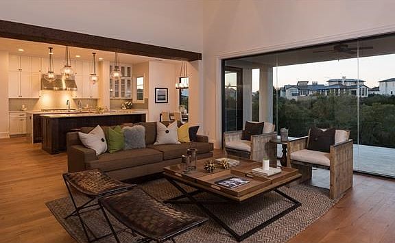 Great Room and kitchen view with walls of glass opening to canyon view.