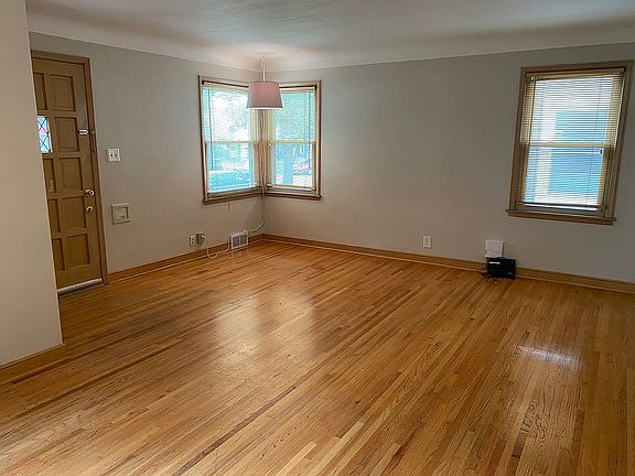 Living room has oak floors.