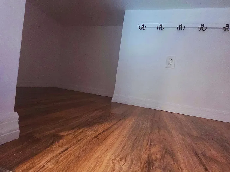 Spacious bedroom with clothing racks for easy, organized storage