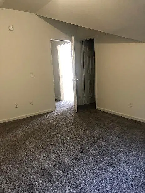 Spacious main bedroom with walk-in closet and wire shelving.