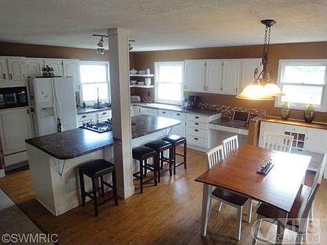 Newly remodeled Kitchen with island, snack bar,flooring, and newer appliances...all will stay.