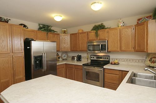Stainless steel appliances and a breakfast bar.