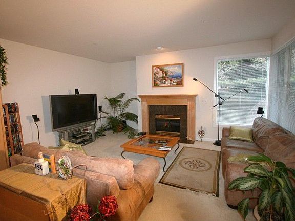 Welcoming family room with gas log fireplace. Sliders to covered patio.