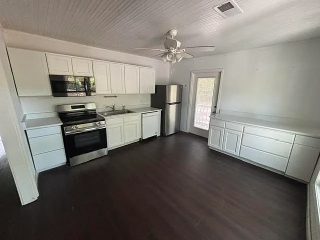 Kitchen with new quartz countertops, new range, new refrigerator.
