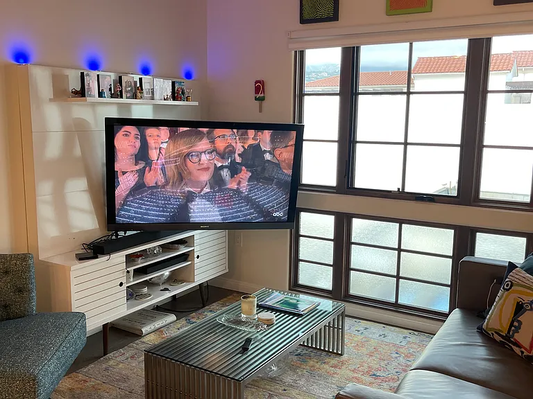 Living room with 55" TV and reclining double couch