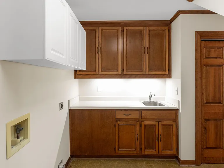 laundry room with sink and storage