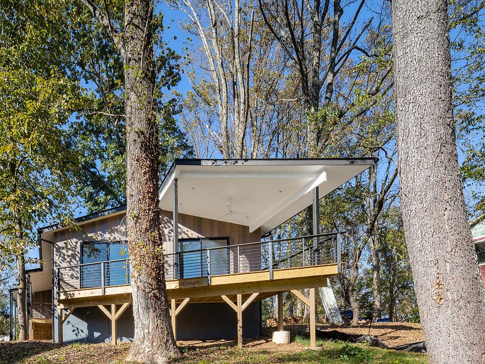 View of back of the house, nestled among mature trees and vegetation. Especial care was taken not to remove existing, mature trees.