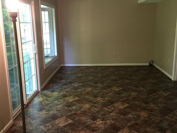 The Family Room has a bay window and sliding glass doors with step access to the backyard. The laundry room door is from this room.
