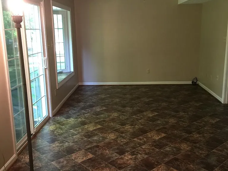 The Family Room has a bay window and sliding glass doors with step access to the backyard. The laundry room door is from this room.