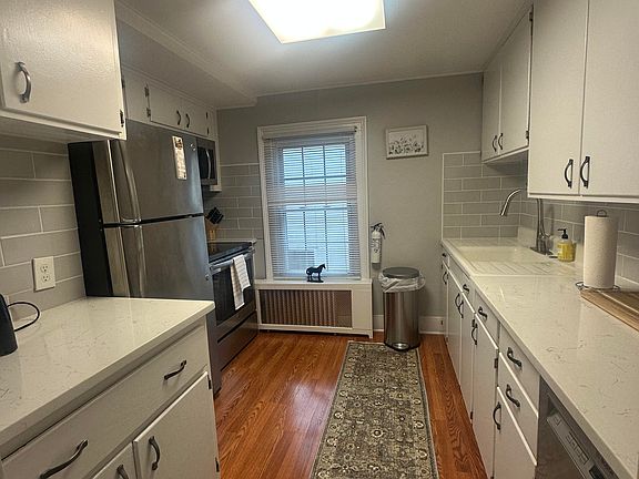 updated kitchen with quartz counter tops, stainless steel fridge, dish washer, oven, microwave