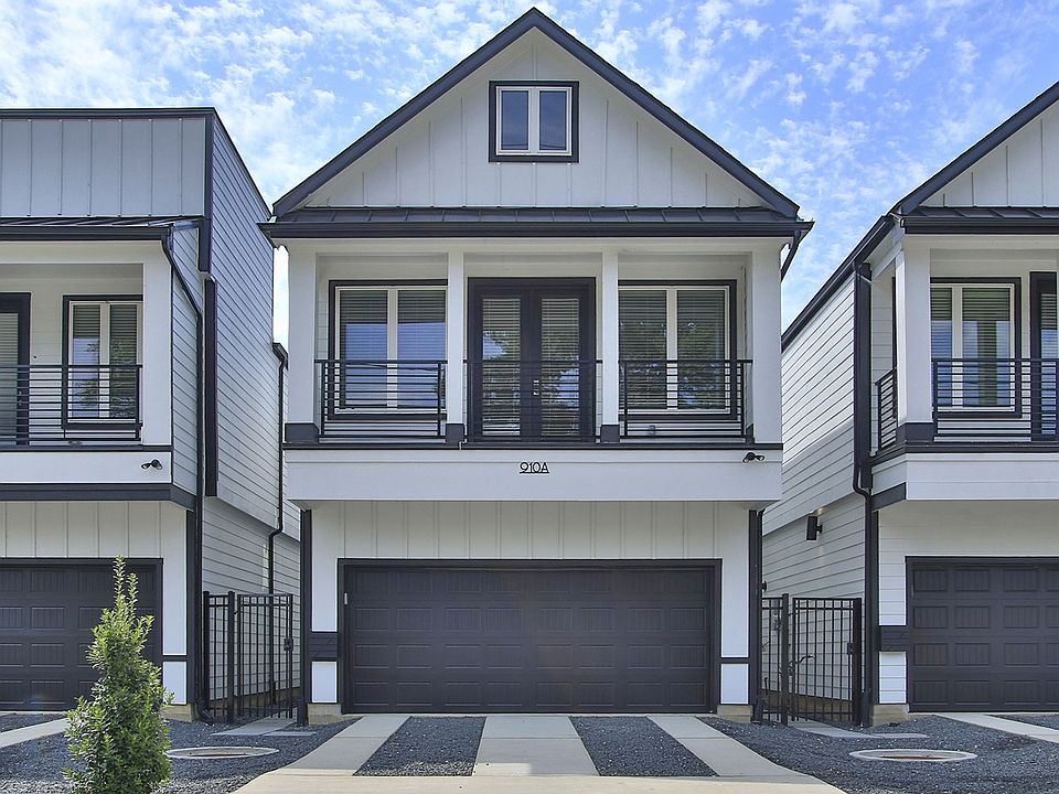 Elegant two-story detached townhomes with a sleek balcony and spacious garage in Shady Acres.