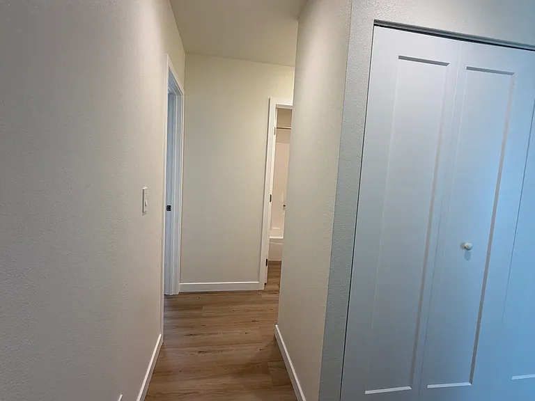 Hallway exiting primary bedroom