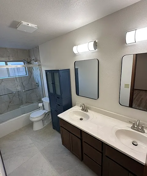 Guest bathroom with Rain shower head and additional magnetic handheld shower head. Dual vanity.