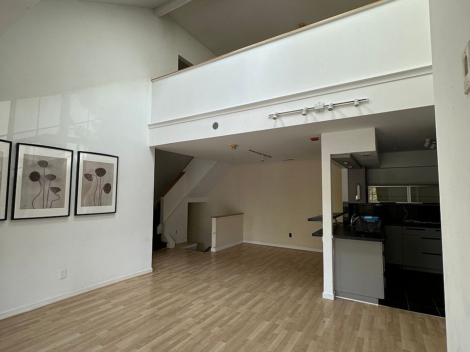 Family room with 2 sky lights, dining room and kitchen