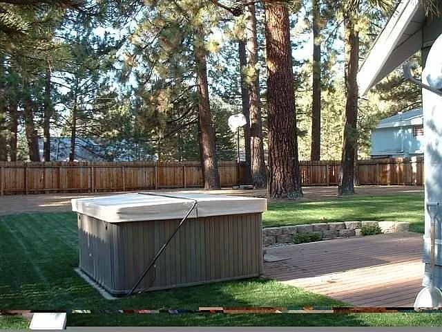 large yard with hot tub
