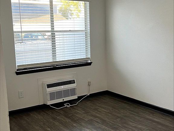 Standing by kitchen counter. To the left is the front door.