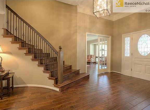 Dramatic roomy entry with beautiful wood floors, barrel staircase including iron spindles!