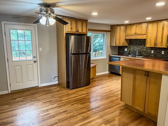 Open living/kitchen/dining area with tons of natural light