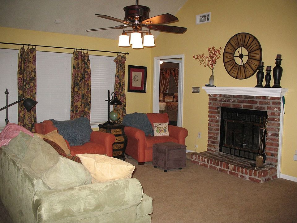 Large family room with vaulted ceilings, masonry fireplace and plenty of light