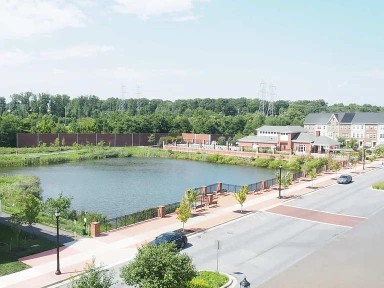 From the rooftop deck, a view of the nearest pond and the community center and swimming pool.