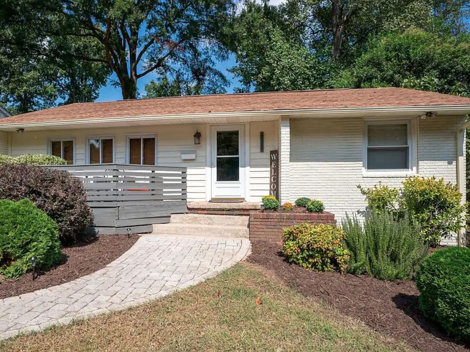 Front porch, paver sidewalk, professionally landscaped.