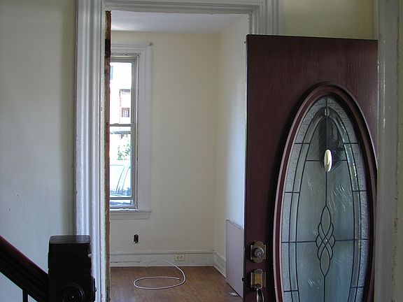 front door and foyer off of porch