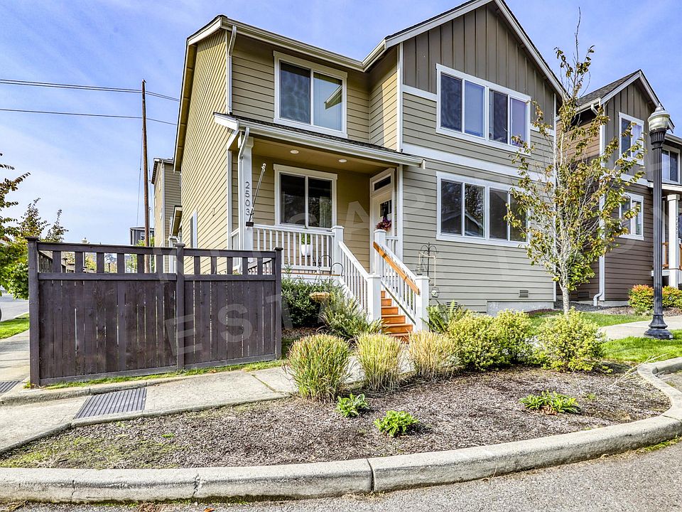 premium corner fenced and gated lot with parking in front plus parking and a 2 car garage in back