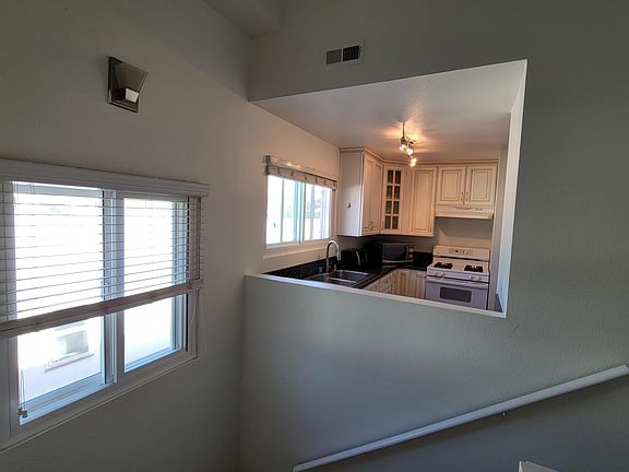 Staircase with view of kitchen