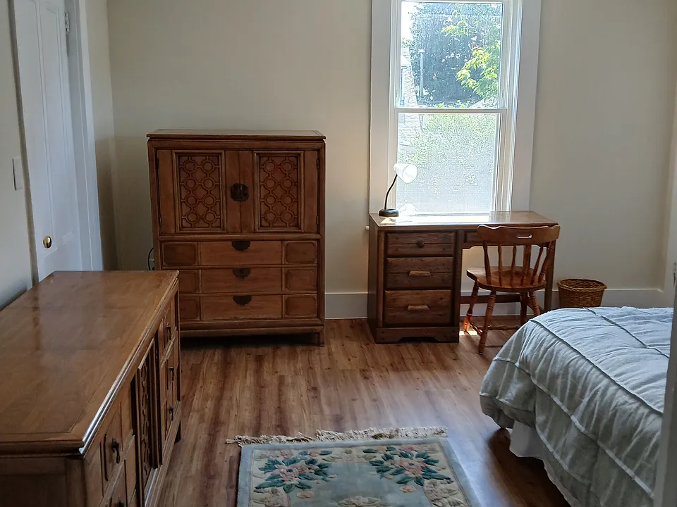 Bedroom has full bed, triple dresser, tall dresser, desk and bookcase