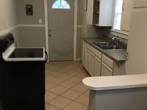 Kitchen view (standing by refrigerator which is not in picture). Washer/Dryer hookups are to the right of stove