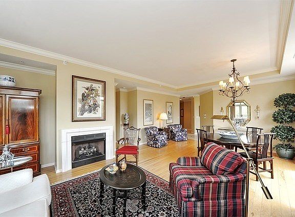 The combination of living and dinging room - bathed in sunlight. Elegant window treatments provide t