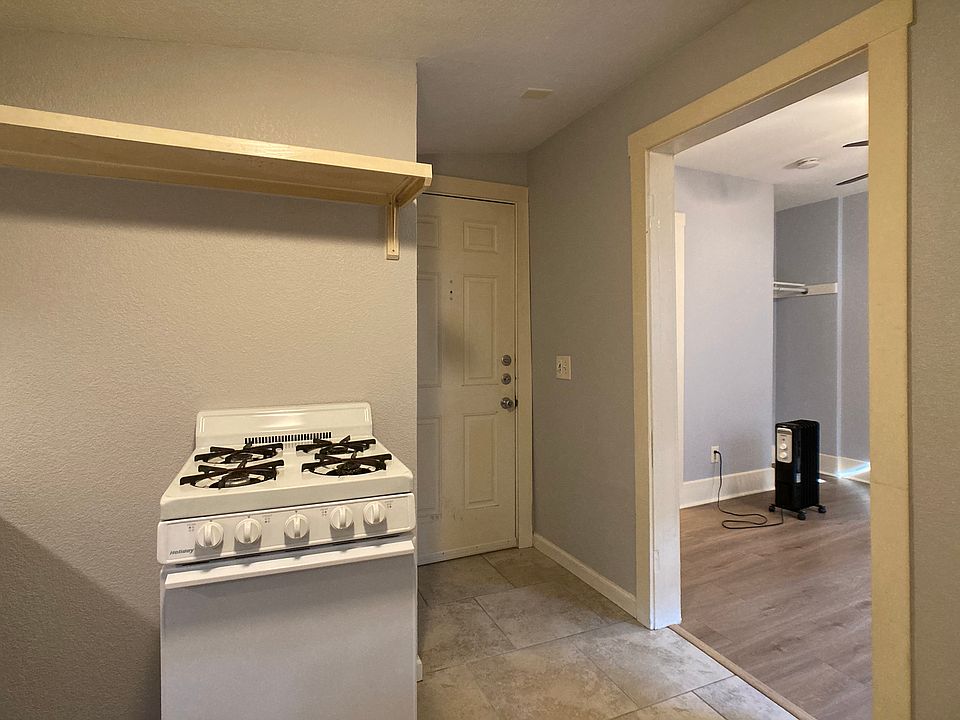 Front entry in background. Bedroom to right.