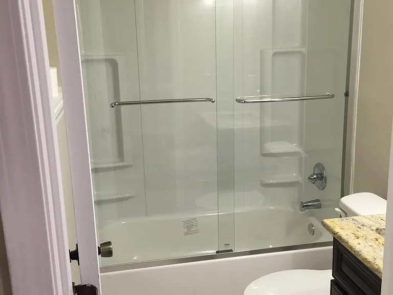 Master Bathroom with granite vanity and glass shower door an