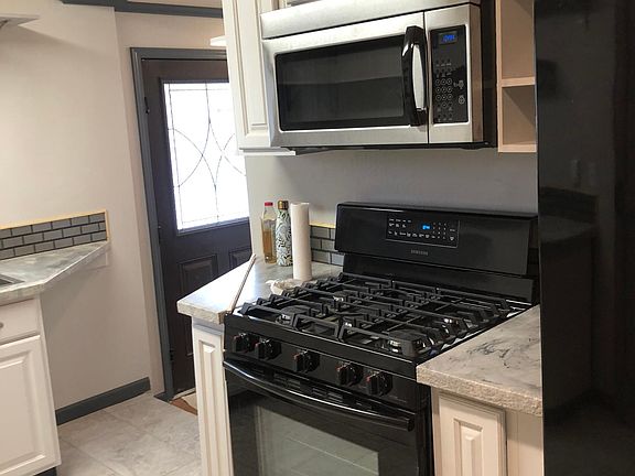 Kitchen with microwave and gas stove