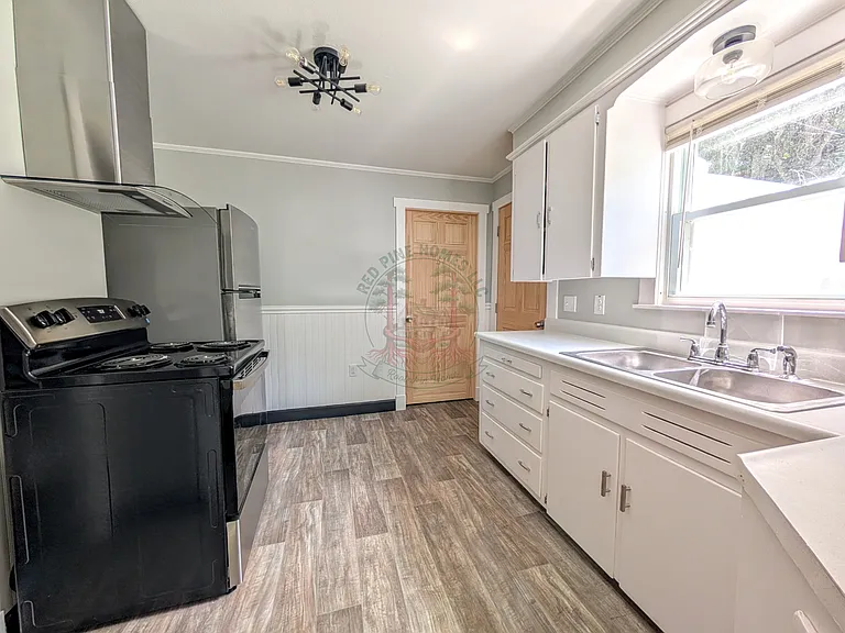 Kitchen. Fan hood exhausts to exterior. New appliances.