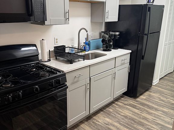 Streamlined kitchen with ample shaker cabinetry, generous counter space, and full-size appliances for everyday cooking.