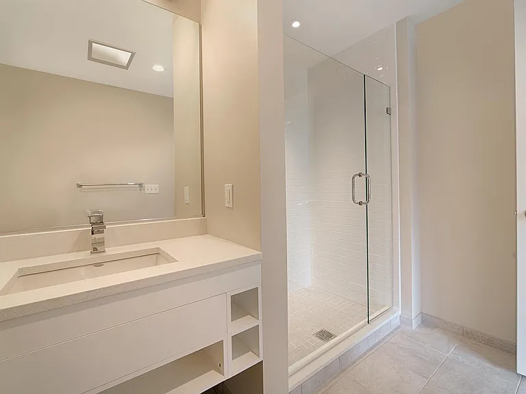 Bathrooms feature modern cabinets, a walk-in shower and a quartz vanity