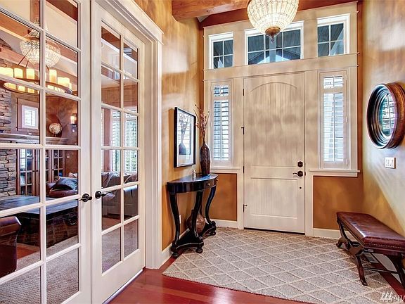 The foyer boasts a vaulted timber beamed ceiling and Brazilian Cherry hardwood floors that flow through the main floor. 
