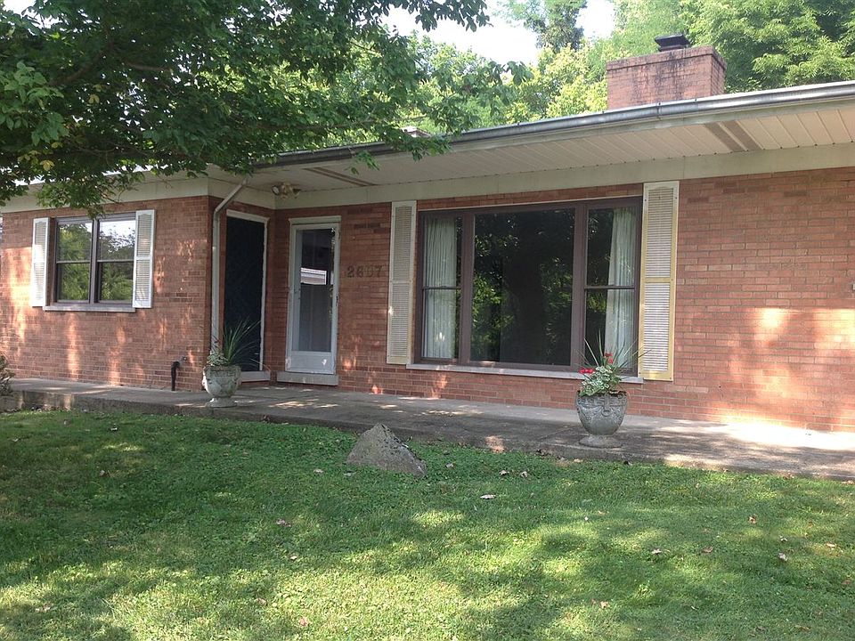 Closeup of apartment front entrance and picture window.