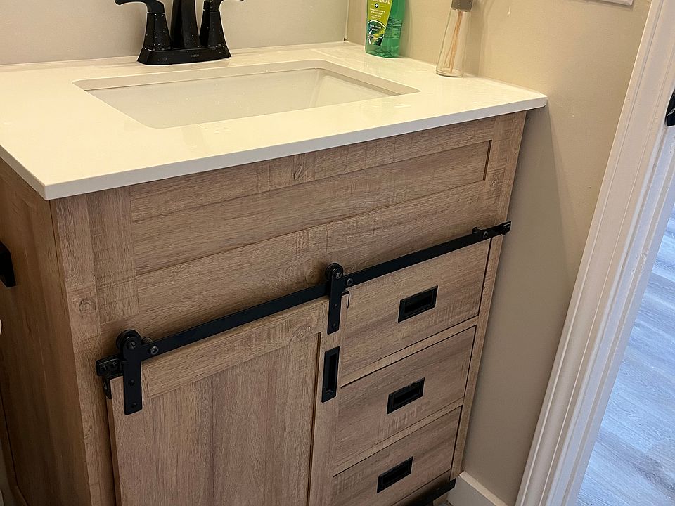 Fresh new bathroom vanity with barn door style. Towel, hand towel, and robe holders for your convenience.