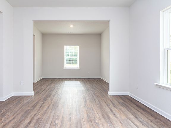 Flex room and formal dining room, both with wood-style flooring and recessed lighting.