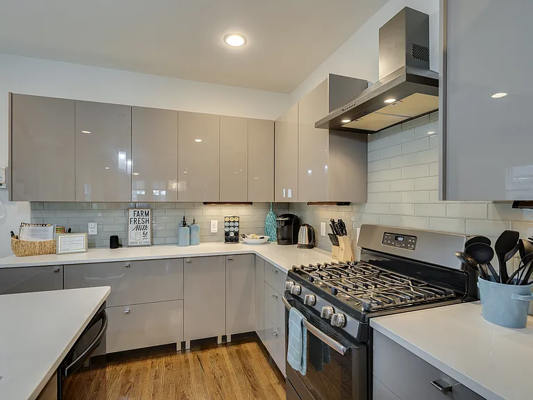 Under-cabinet lighting creates a warm ambiance, while the chef's kitchen features a 6-burner gas range, Keurig, traditional coffee maker, tea kettle, and everything you need to enjoy your favorite morning beverage.